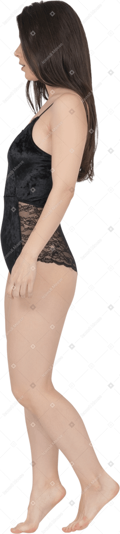 Woman in black bodysuit posing in profile