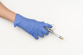 Female hand holding a syringe