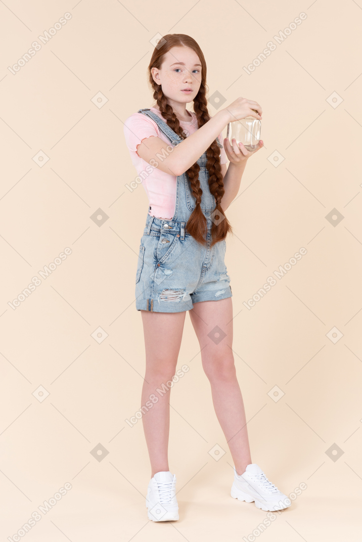 Teenage girl holding jar