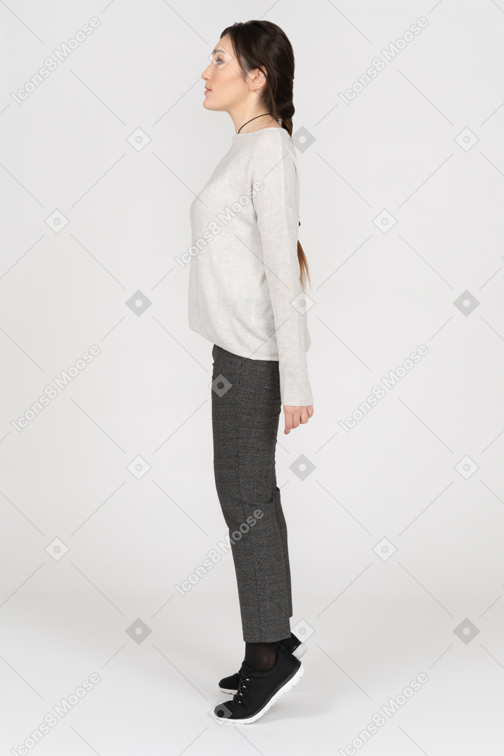 Slim caucasian female standing on tiptoes in profile
