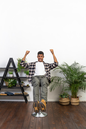 Good looking young man sitting on a chair