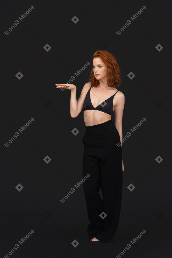 A frontal view of the beautiful woman dressed in black and posing