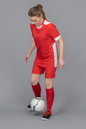 A female football player driving a ball