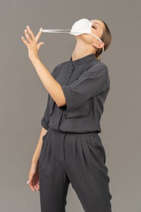 Woman pulling on the strings of the respirator