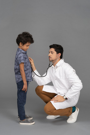 Doctor examining little child