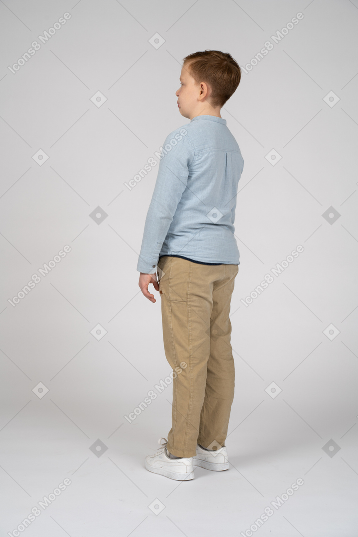Boy in casual clothes standing in profile
