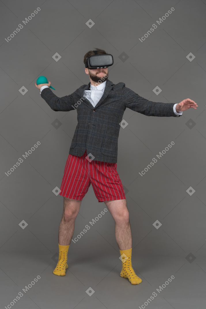 Man in vr headset is ready to throw the object