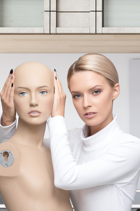 A woman covering ears to a mannequin