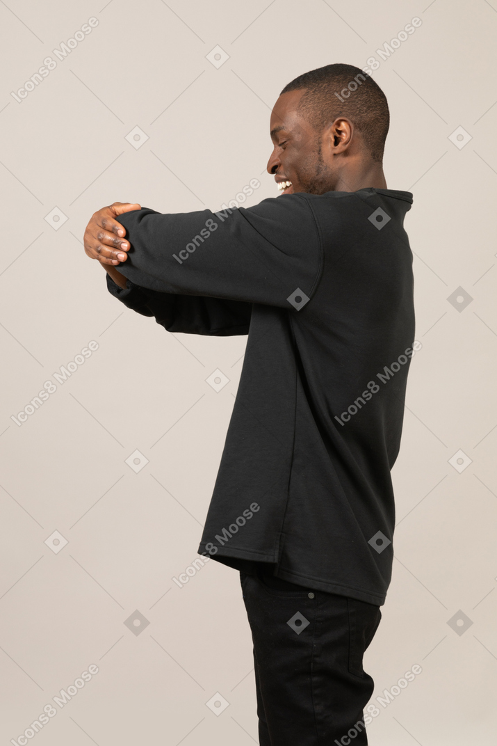 Side view of young man hugging something