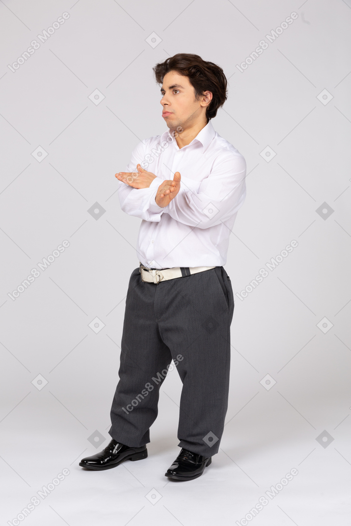 Male office worker showing stop gesture with crossed hands