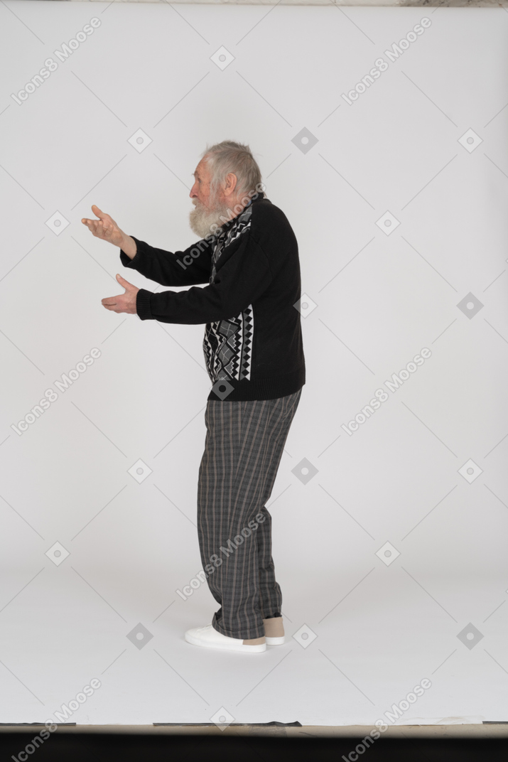 Side view of old man gesturing