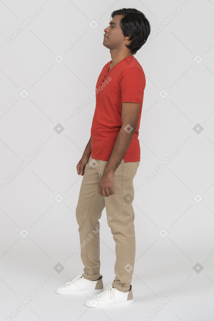 Side view of young man standing casually