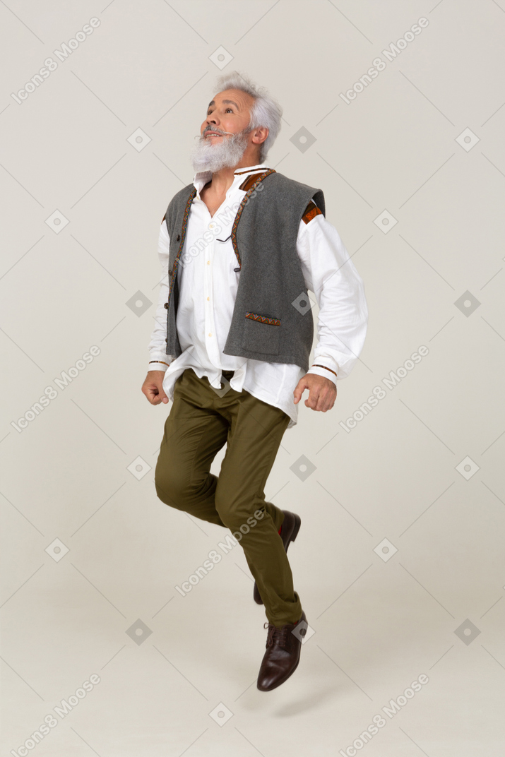 Man in gray vest jumping up