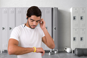 A man is standing in front of a row of lockers