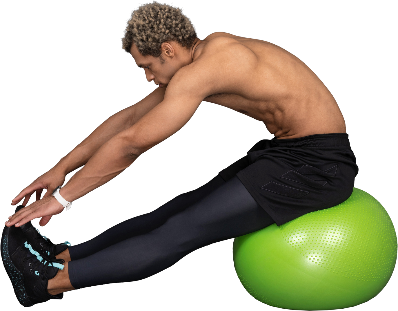 Side view of a shirtless afro man stretching while sitting on a green