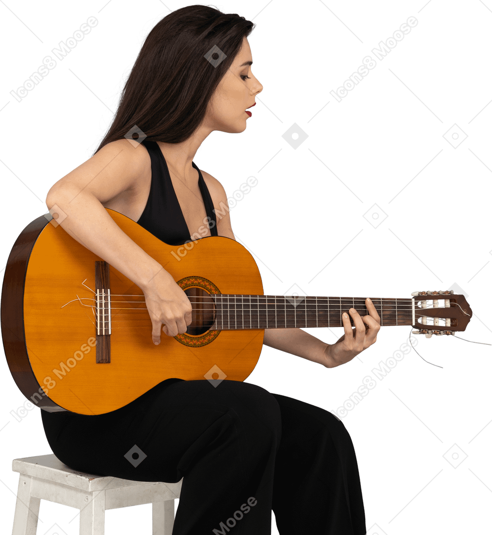 Three-quarter view of a sitting young lady in black suit playing guitar