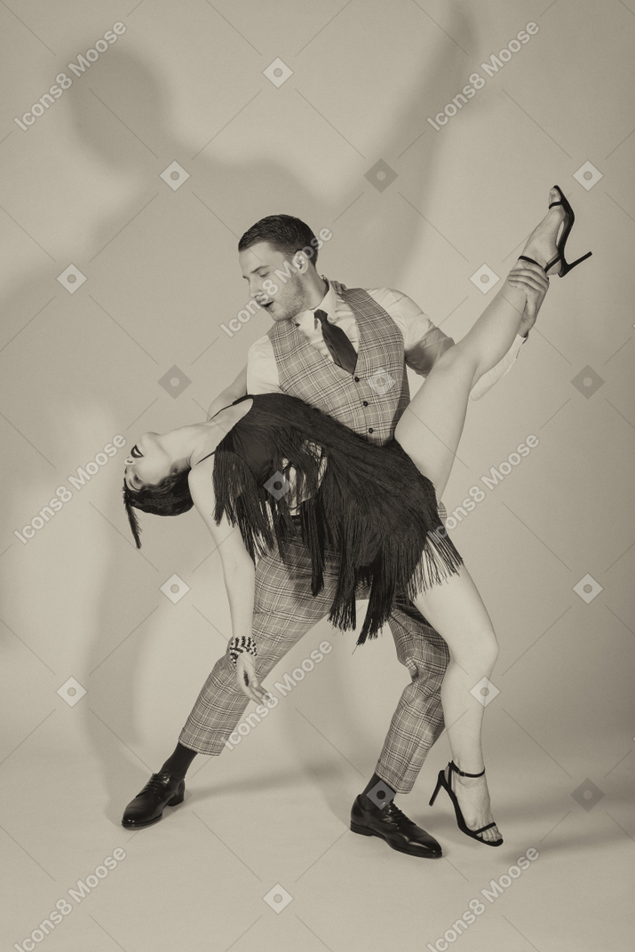 Stylish dancers performing charleston dance