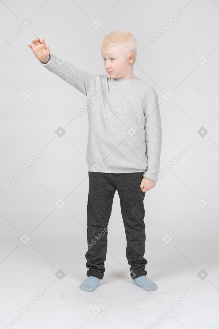 Front view of a boy grabbing something