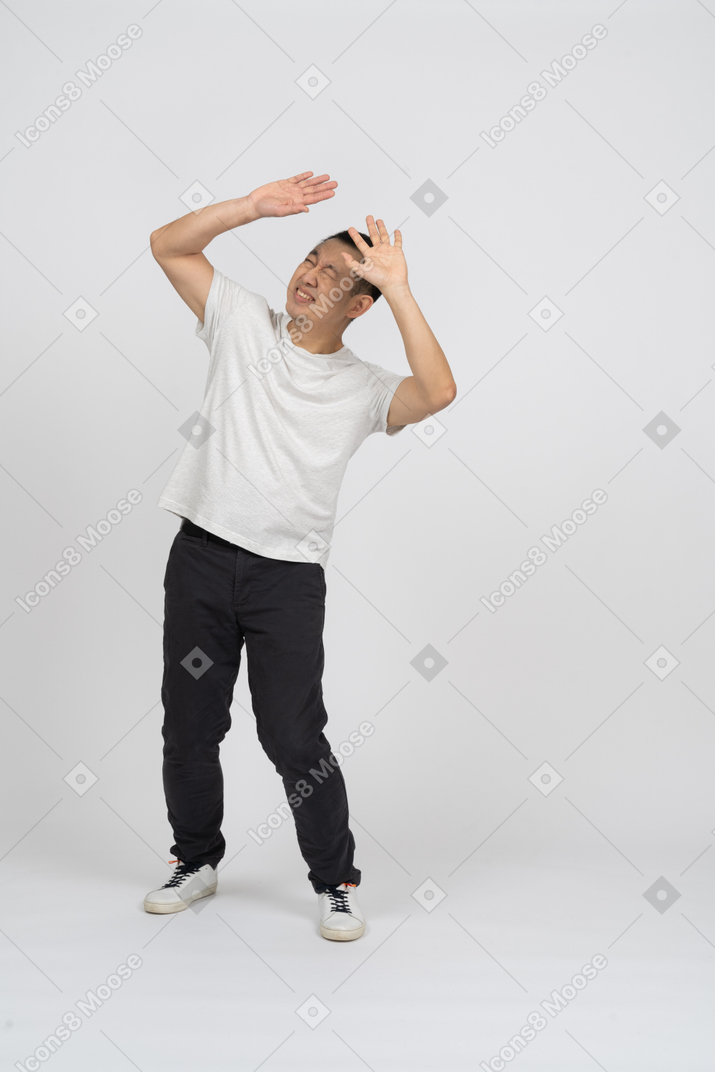 Man with raised hands looking up