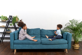 Good looking boy and girl play on the sofa