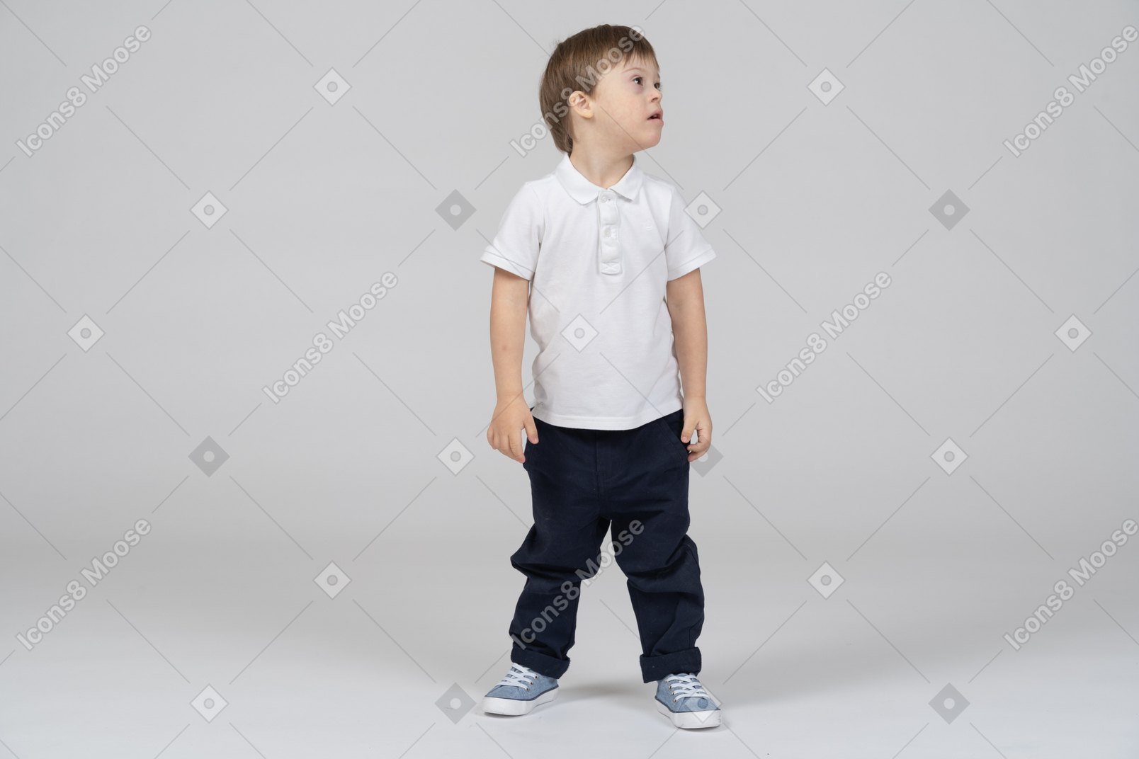 Little boy standing with his head turned