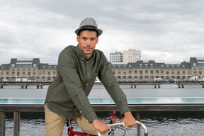 A man in a hat riding a bike