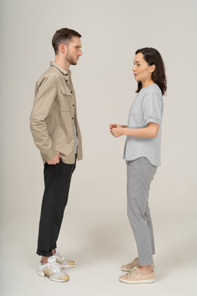 Side view of young couple speaking to each other