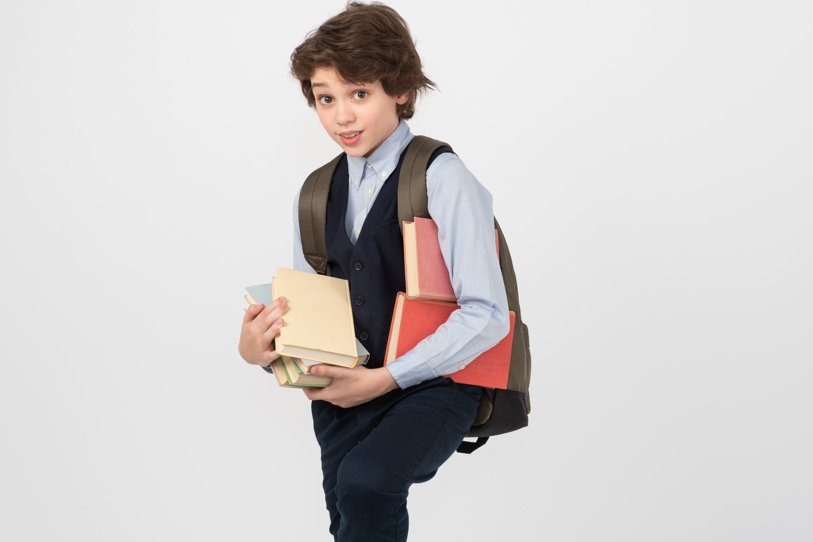 Schoolboy carrying a bunch of books