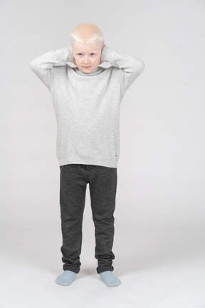 Boy covering his ears with hands