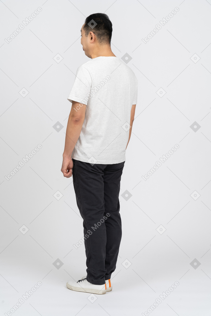 Man in casual clothes standing back to camera