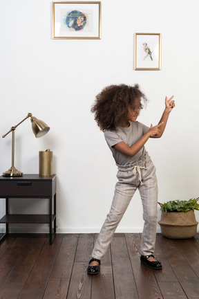 Good looking girl kid posing on the apartment background