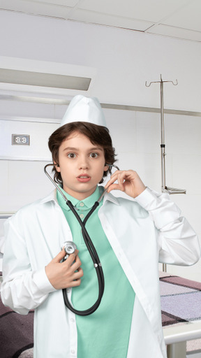 A boy dressed as a doctor using a stethoscope