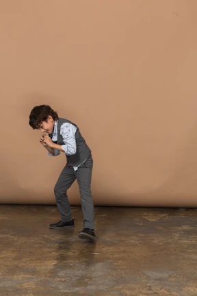 Front view of a boy in suit is ready to fight