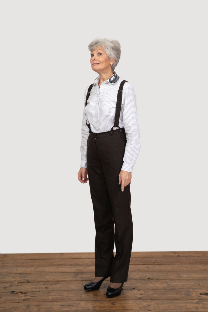 Three-quarter view of a perplexed old woman in office clothing