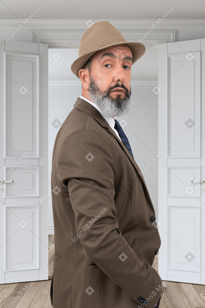 Elegant man is looking back before going outdoors
