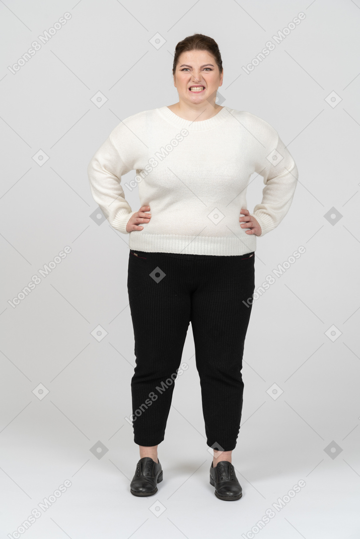 Angry plump woman in casual clothes making faces