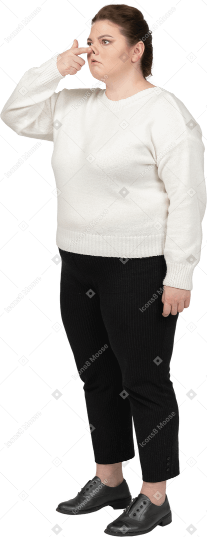 Plump woman in casual clothes touching nose