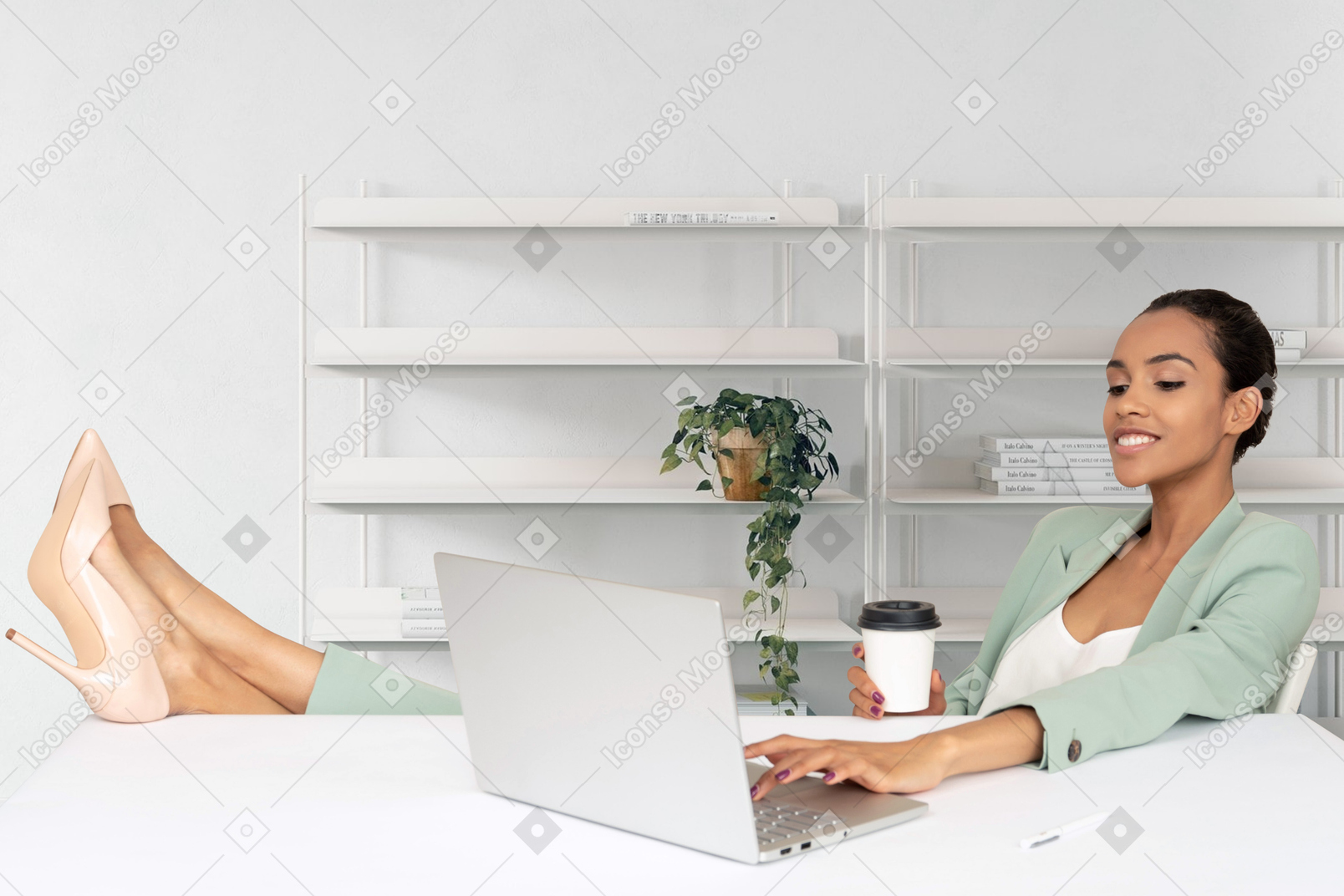 A woman sitting at a desk with a laptop