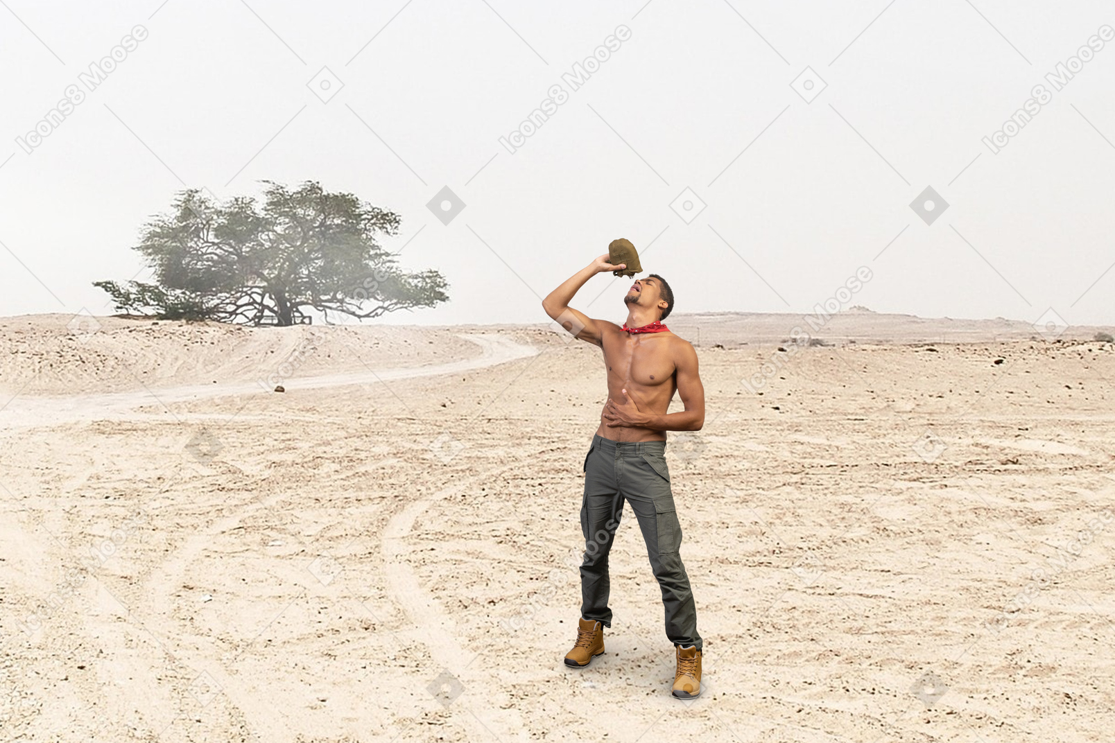 A man standing in the middle of a desert holding a water flask