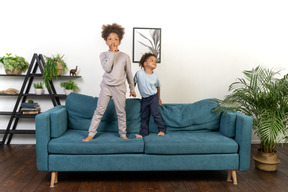 Good looking boy and girl play on the sofa