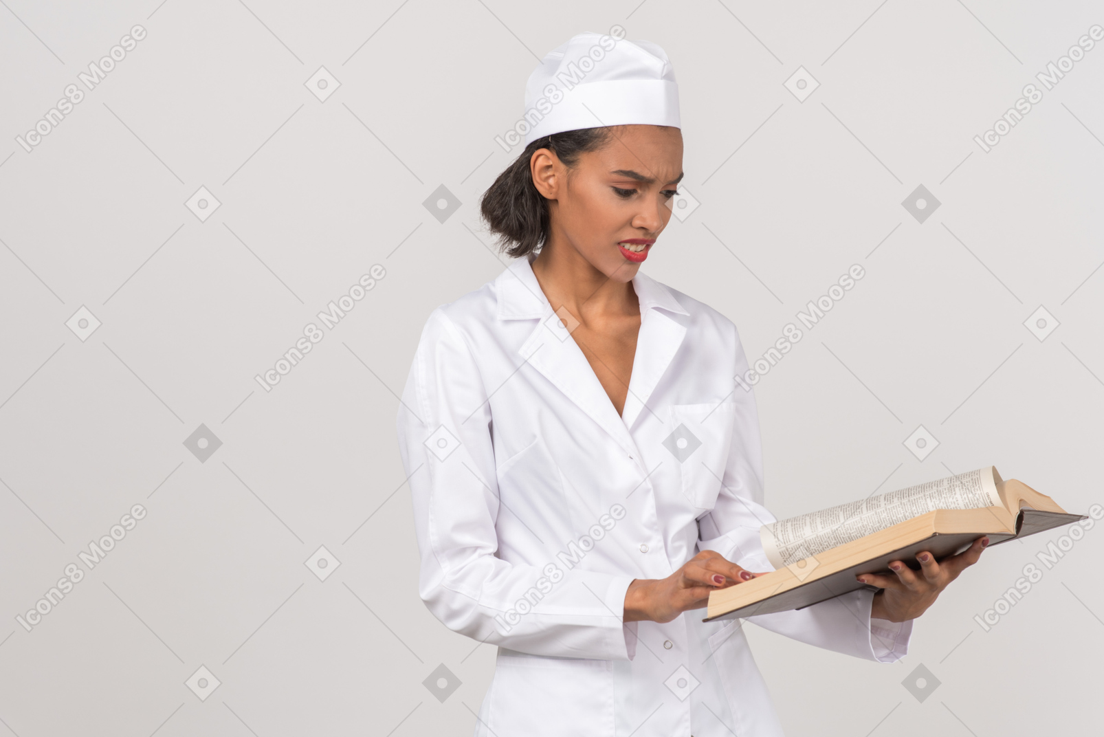 Attractive female doctor looking for something in a book