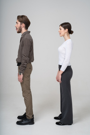 Side view of a young couple in office clothing licking lips