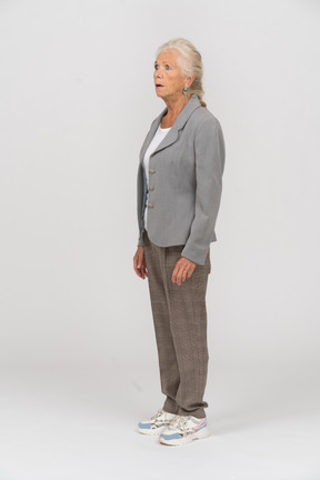 Side view of an impressed old lady in suit