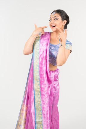 Thrilled looking young indian woman in purple sari