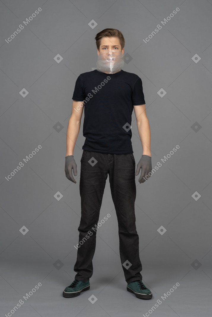 Male model in gray latex gloves on neutral background