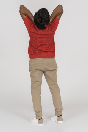 Back view of young man holding his head