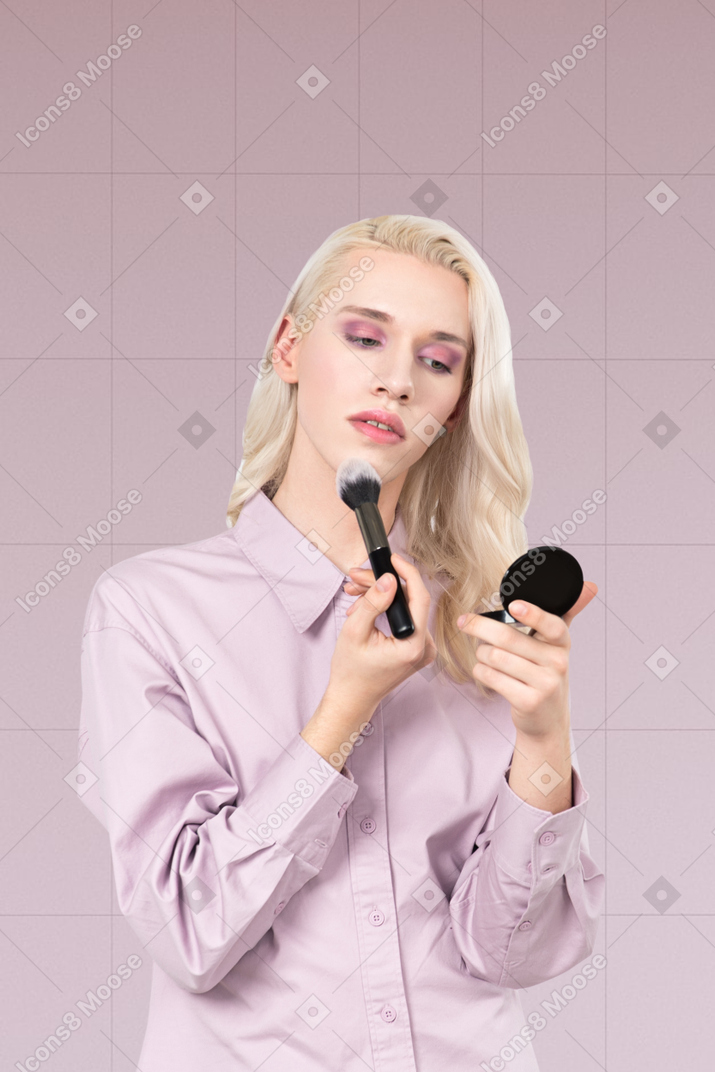 Blonde person doing their make up