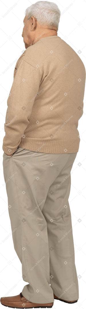 Vista laterale di un vecchio in abiti casual in piedi con le mani in tasca