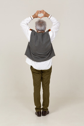 Back view of a man making a hand heart