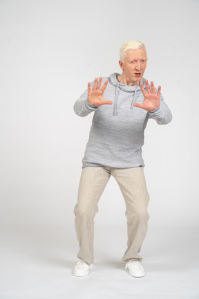 Man showing stop gesture with two hands